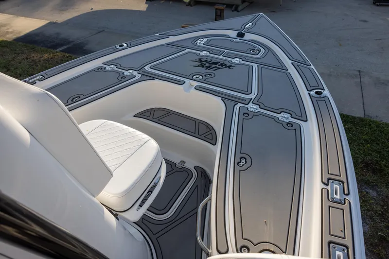 Slide: The Image of 2024 Sea Pro 210 Bay boat deck with cushioned seating and sleek design. - 12