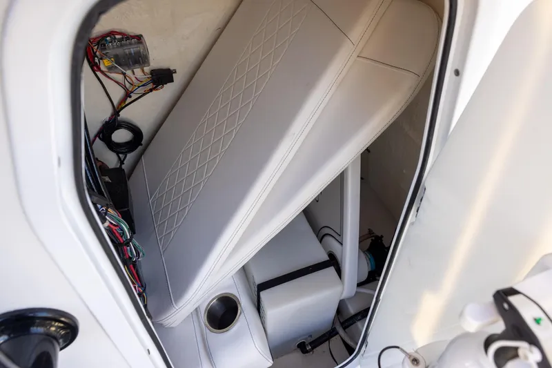 Slide: The Image of 2024 Sea Pro 210 Bay boat interior with wiring and storage compartment. - 13