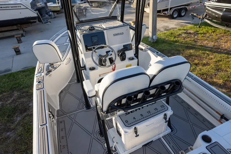 Slide: The Image of 2024 Sea Pro 210 Bay boat interior with steering console and seating. - 4