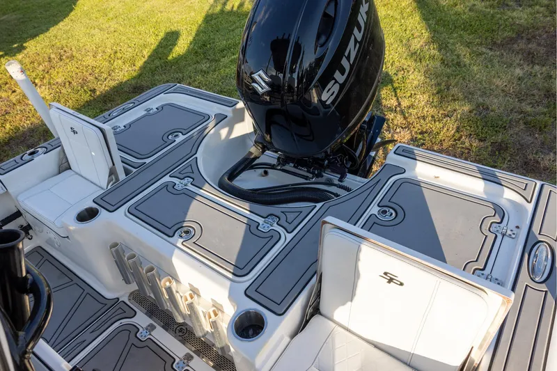Slide: The Image of 2024 Sea Pro 210 Bay boat with Suzuki engine, featuring sleek deck design and storage compartments. - 5