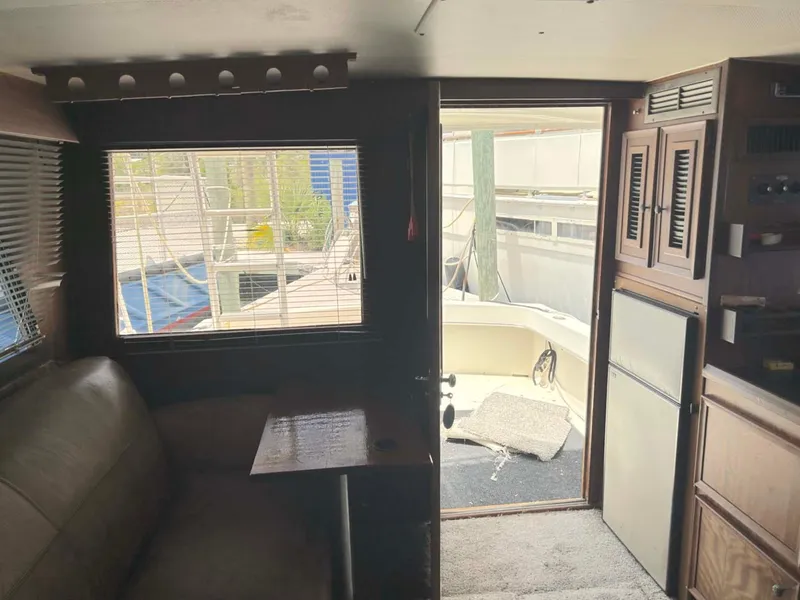 Slide: The Image of Interior of a 1975 Hatteras 36 Convertible yacht with seating and outdoor view. - 10