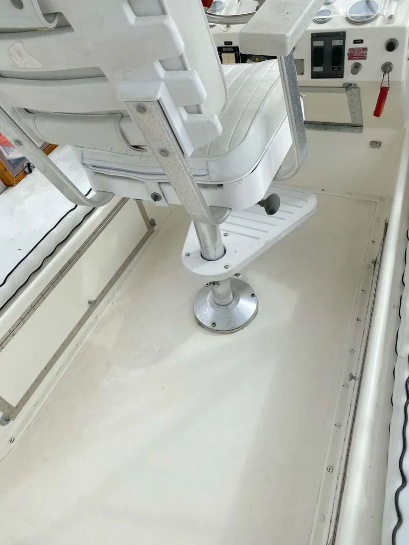 Slide: The Image of 1975 Hatteras 36 Convertible boat interior with white captain's chair and control panel. - 41