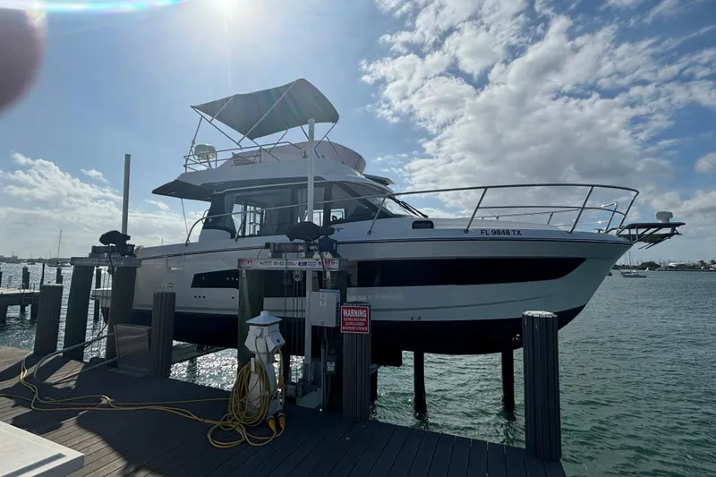 Slide: The Image of 2024 Jeanneau NC Weekender 1095 Fly docked, showcasing sleek design and modern features. - 2