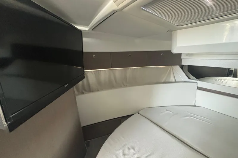 Slide: The Image of 2024 Jeanneau NC Weekender 1095 Fly cabin interior with TV and modern furnishings. - 20
