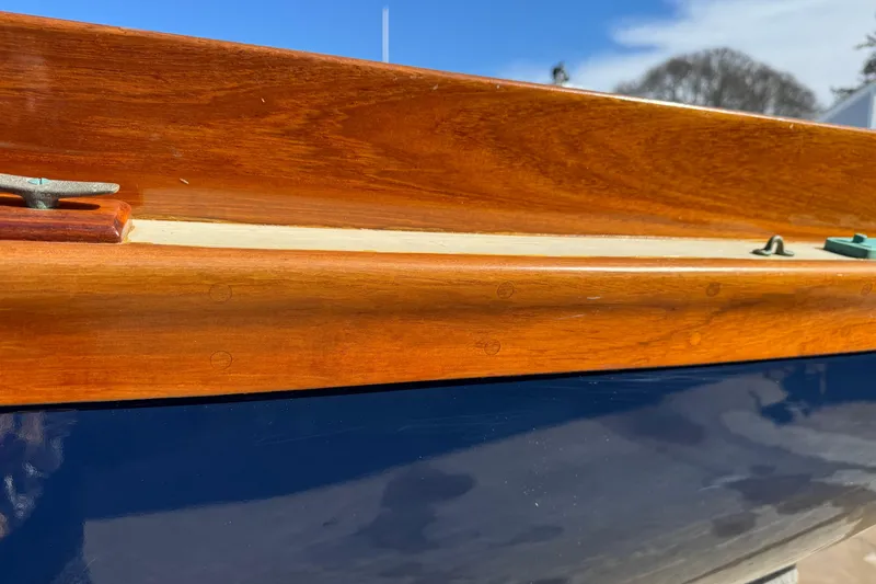 Slide: The Image of 2018 Ballentine's Boat Shop Doughdish with polished wood and blue hull detail. - 12