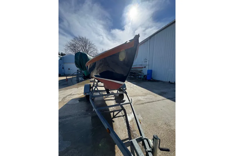 Slide: The Image of 2018 Ballentine's Boat Shop Doughdish sailboat on trailer under sunny sky. - 20