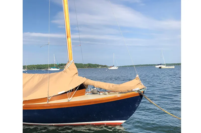 Slide: The Image of 2018 Edey & Duff Herreshoff 12 1/2 sailboat on calm water. - 22