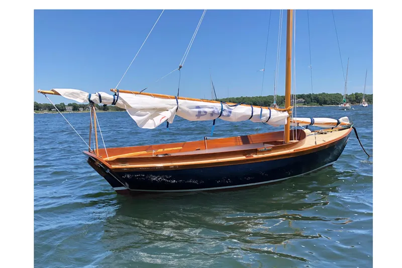 Slide: The Image of 2018 Ballentine's Boat Shop Doughdish sailboat on calm water, clear blue sky. - 3