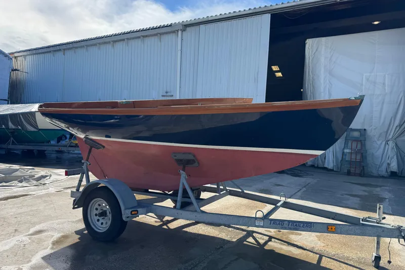 Slide: The Image of 2018 Ballentine's Boat Shop Doughdish sailboat on trailer outside a warehouse. - 5