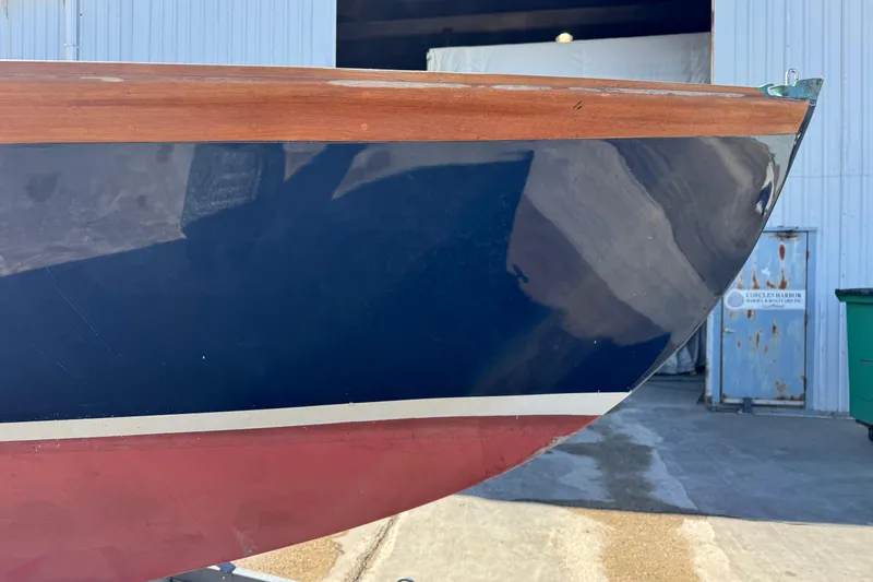 Slide: The Image of 2018 Ballentine's Boat Shop Doughdish sailboat bow in a shipyard setting. - 6