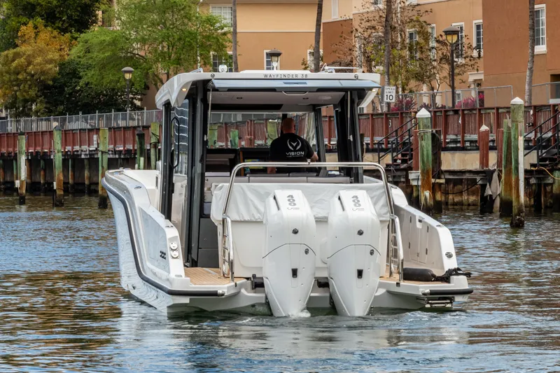 Slide: The Image of Aiata Wayfinder 38 Cabin 2026 on water near dock. - 3