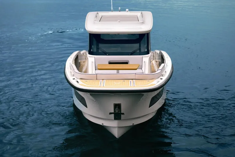 Slide: The Image of 2026 Aiata Wayfinder 38 Cabin boat on calm water, front view. - 9