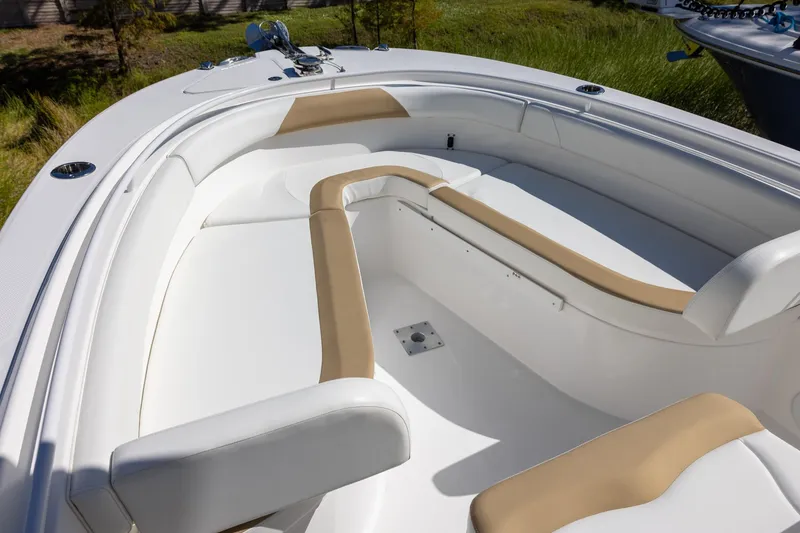 Slide: The Image of 2023 Edgewater 245CC boat interior with white and tan seating. - 12