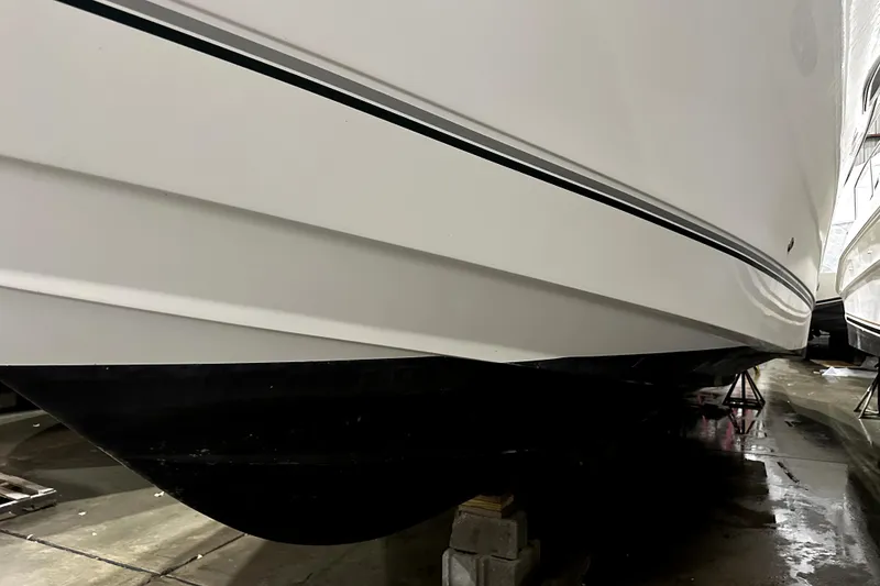 Slide: The Image of 2002 Four Winns 378 Vista boat hull in storage, side view. - 10