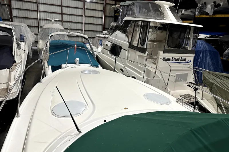 Slide: The Image of 2002 Four Winns 378 Vista boat in storage, surrounded by other covered vessels. - 11