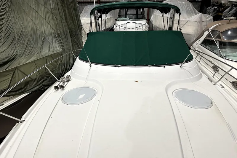 Slide: The Image of 2002 Four Winns 378 Vista boat with green cover in storage. - 12