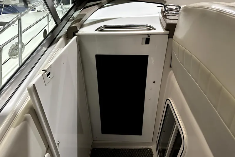 Slide: The Image of Interior view of 2002 Four Winns 378 Vista boat, featuring cabin entrance and seating area. - 17