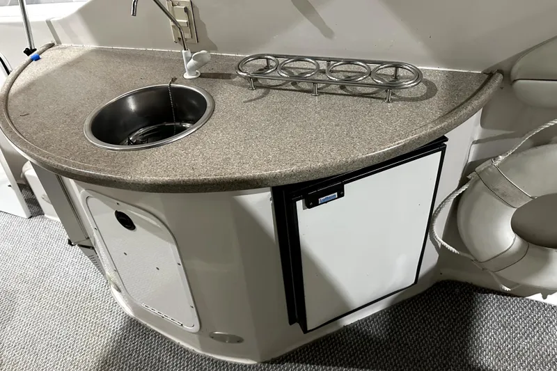 Slide: The Image of 2002 Four Winns 378 Vista boat kitchenette with sink and mini fridge. - 20