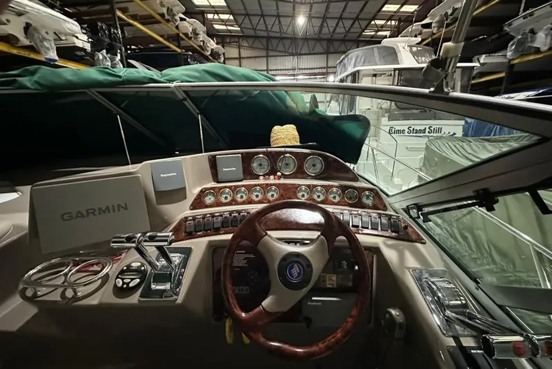 Slide: The Image of 2002 Four Winns 378 Vista boat dashboard with Garmin navigation in a storage facility. - 24