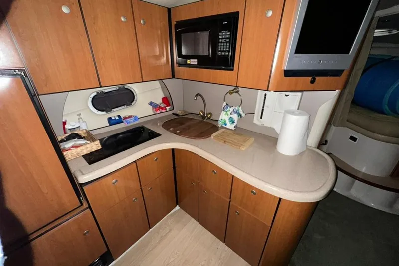 Slide: The Image of 2002 Four Winns 378 Vista yacht kitchen with wood cabinets and modern appliances. - 33