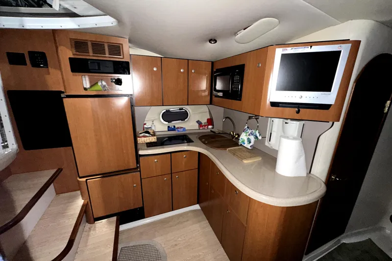 Slide: The Image of 2002 Four Winns 378 Vista yacht interior kitchen with wood cabinets and modern appliances. - 34