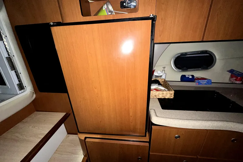 Slide: The Image of Interior of 2002 Four Winns 378 Vista yacht with wooden cabinetry and compact kitchen area. - 37