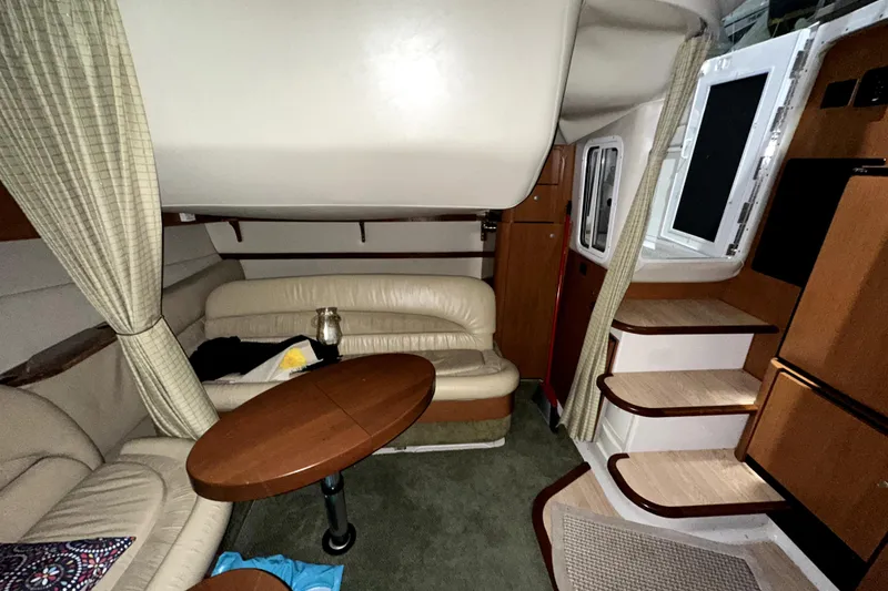 Slide: The Image of Interior of 2002 Four Winns 378 Vista yacht with cozy seating and wooden table. - 43