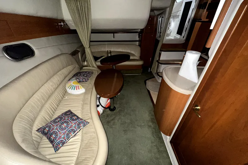 Slide: The Image of Interior of 2002 Four Winns 378 Vista yacht with beige seating and wooden accents. - 44