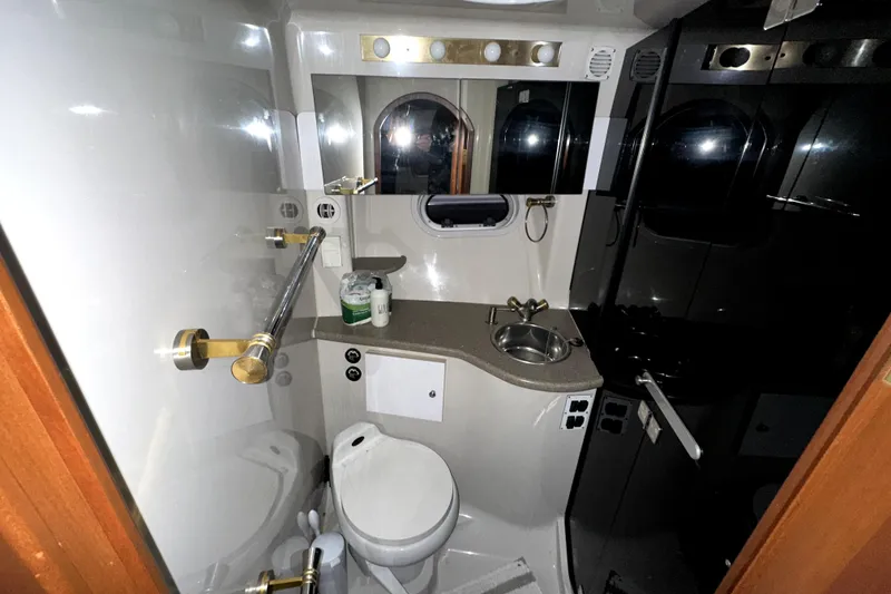 Slide: The Image of 2002 Four Winns 378 Vista yacht bathroom with toilet, sink, and mirror. - 50