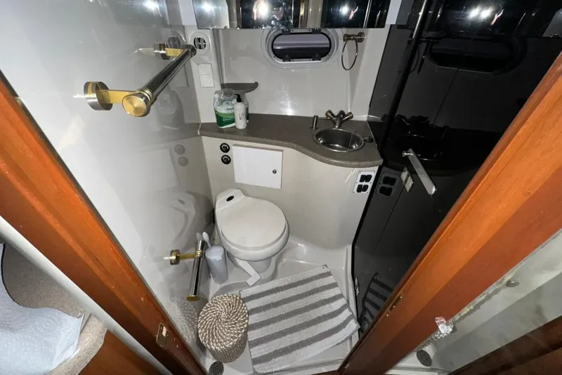 Slide: The Image of Compact bathroom in 2002 Four Winns 378 Vista yacht with toilet, sink, and mirror. - 51