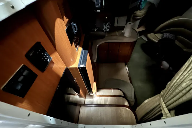 Slide: The Image of Interior of 2002 Four Winns 378 Vista yacht, featuring wood paneling and compact design. - 52