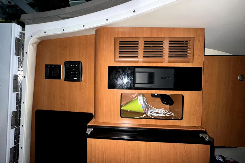 Slide: The Image of Interior of 2002 Four Winns 378 Vista boat with wooden paneling and storage compartments. - 54