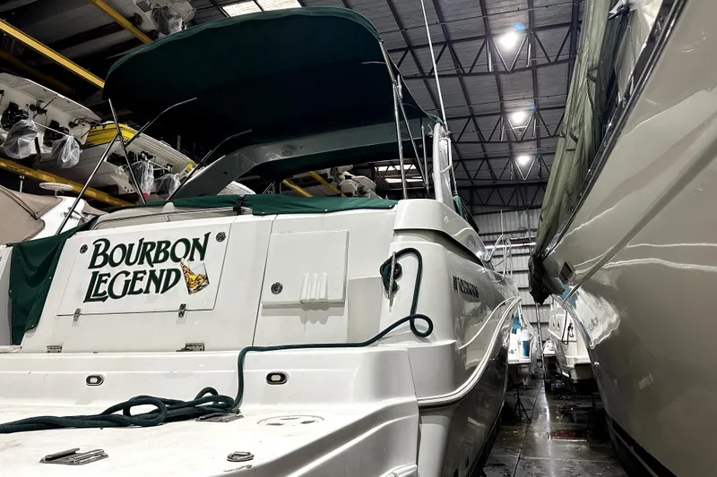Slide: The Image of 2002 Four Winns 378 Vista boat named "Bourbon Legend" in indoor storage facility. - 6
