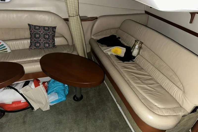 Slide: The Image of Interior of 2002 Four Winns 378 Vista yacht with beige leather seating and wooden tables. - 60