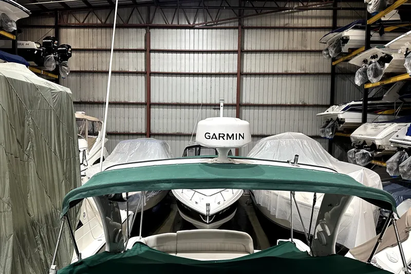 Slide: The Image of 2002 Four Winns 378 Vista boat stored in a covered marina with Garmin equipment. - 61