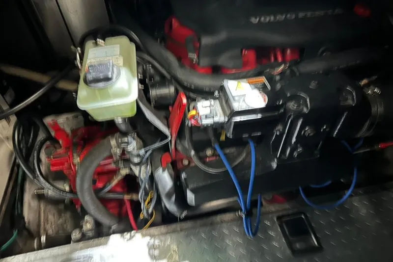 Slide: The Image of Engine compartment of a 2002 Four Winns 378 Vista boat, featuring Volvo Penta components. - 67