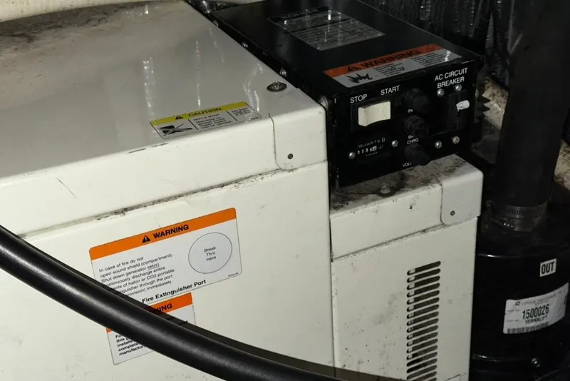 Slide: The Image of Electrical panel with warning labels on a 2002 Four Winns 378 Vista boat. - 70
