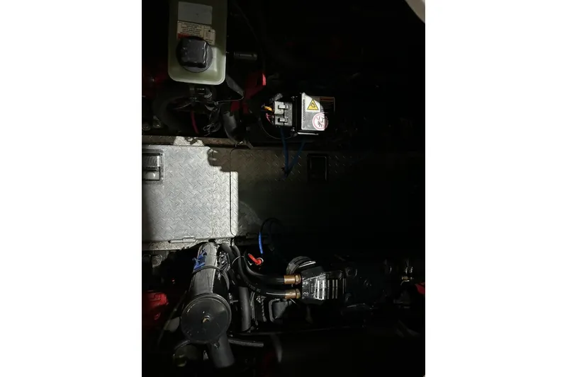 Slide: The Image of Engine compartment of 2002 Four Winns 378 Vista boat, showcasing mechanical components. - 71