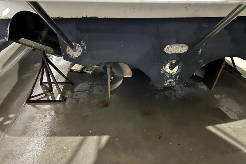 Slide: The Image of 2002 Four Winns 378 Vista boat hull and propeller in maintenance setting. - 8