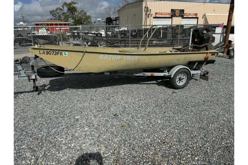 Slide: The Image of Custom BFC Marine 16 boat on trailer, 2004 model, parked on gravel lot. - 2