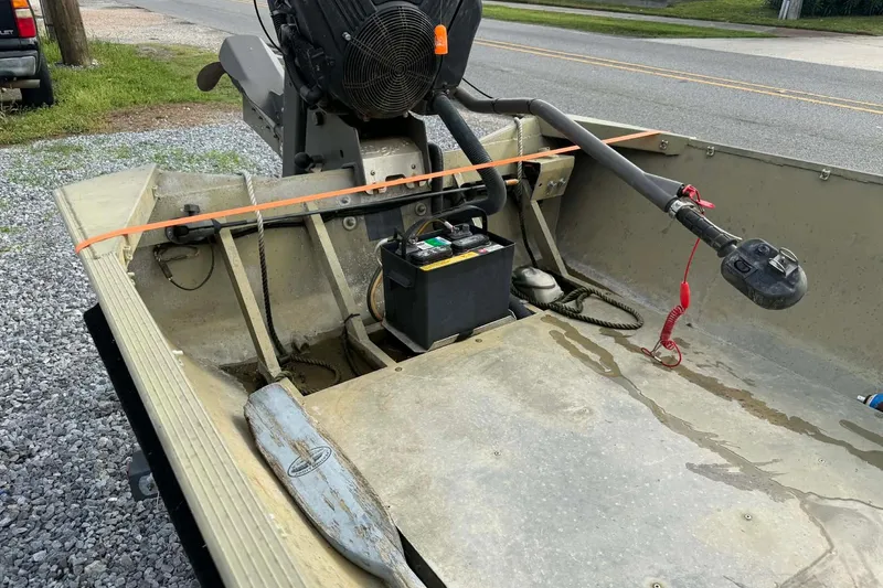 Slide: The Image of 2004 Custom BFC Marine 16 boat interior with motor and battery setup. - 4