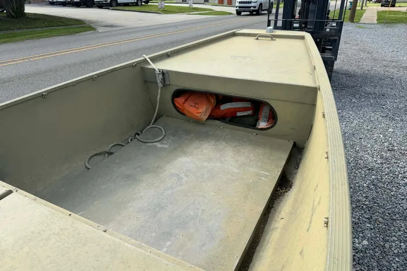 Slide: The Image of Custom BFC Marine 16 boat, 2004 model, with storage compartment and life jackets. - 5