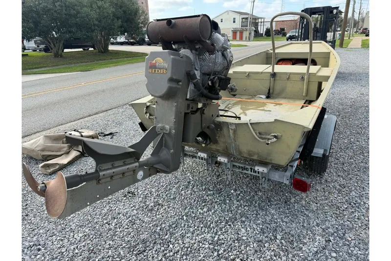 Slide: The Image of 2004 Custom BFC Marine 16 boat on trailer with outboard motor, parked on gravel. - 7
