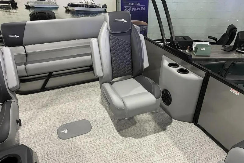 Slide: The Image of 2026 Bennington S Swingback 23 SSB interior with gray seating and cup holders. - 5
