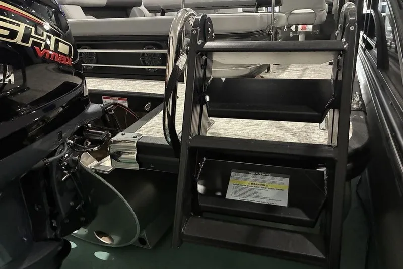 Slide: The Image of 2026 Bennington S Swingback 23 SSB boat with ladder and engine detail. - 8