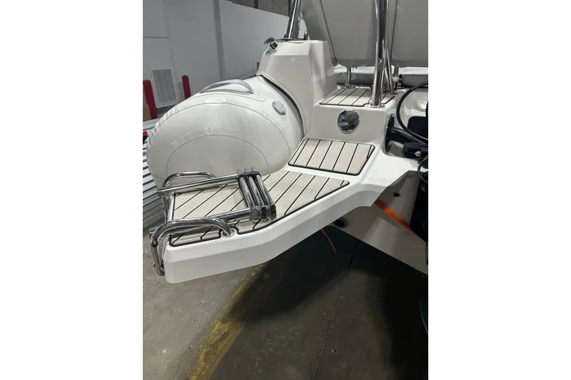 Slide: The Image of 2025 Zodiac Medline 6.8 boat interior with logo and seating detail. - 12
