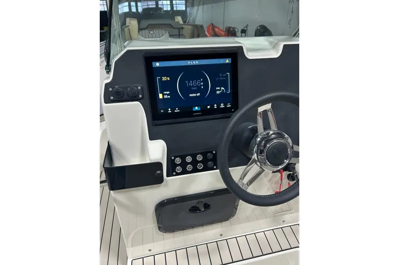 Slide: The Image of 2025 Zodiac Medline 6.8 boat dashboard with touchscreen display and steering wheel. - 21