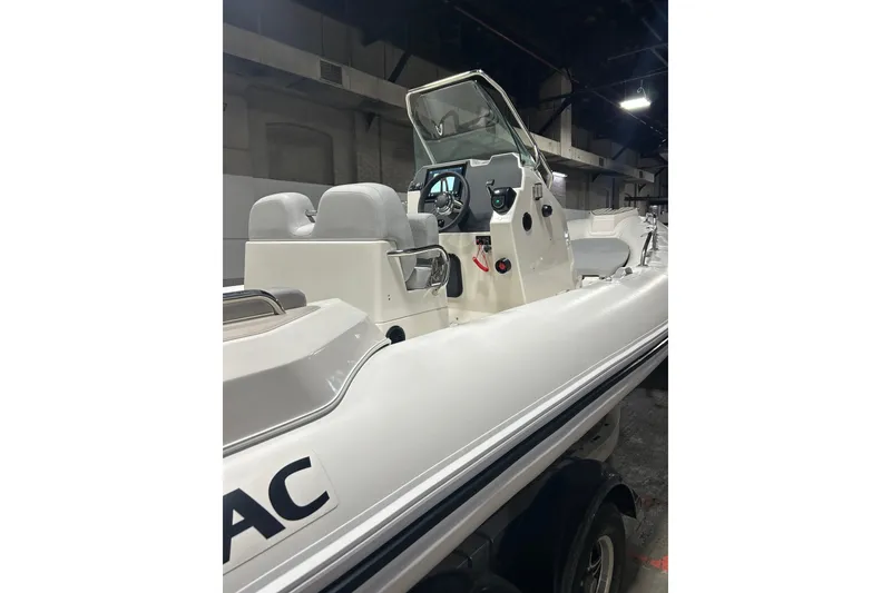 Slide: The Image of Zodiac Medline 6.8 boat on open water, 2025 model, under clear blue sky. - 3