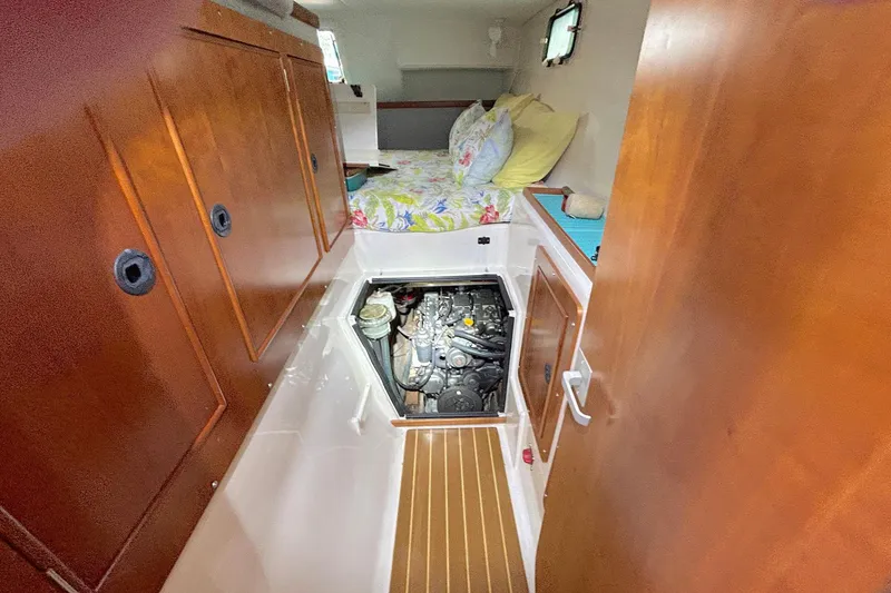 Slide: The Image of 2004 PDQ 34 Power Catamaran interior with engine access and cozy cabin. - 66