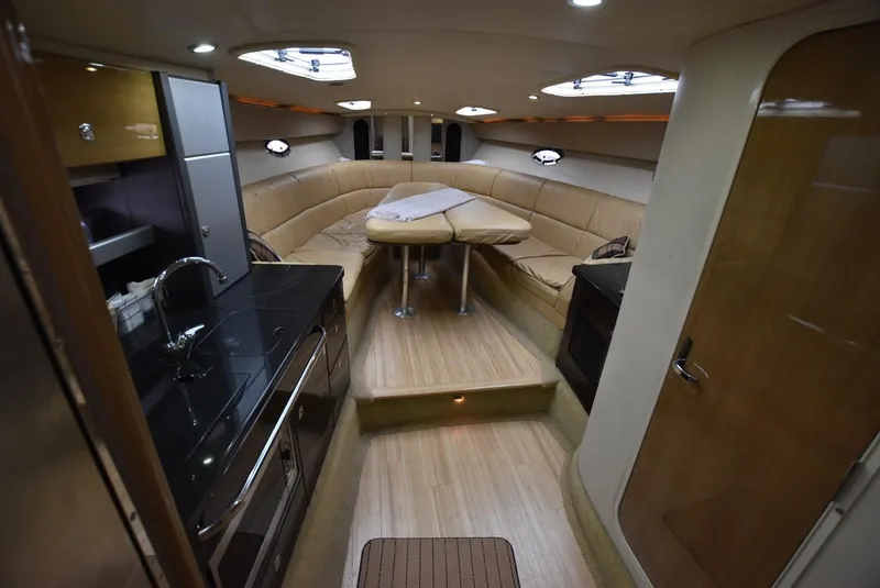 Slide: The Image of 2011 Formula 400ss yacht interior with kitchen, seating area, and wooden flooring. - 13